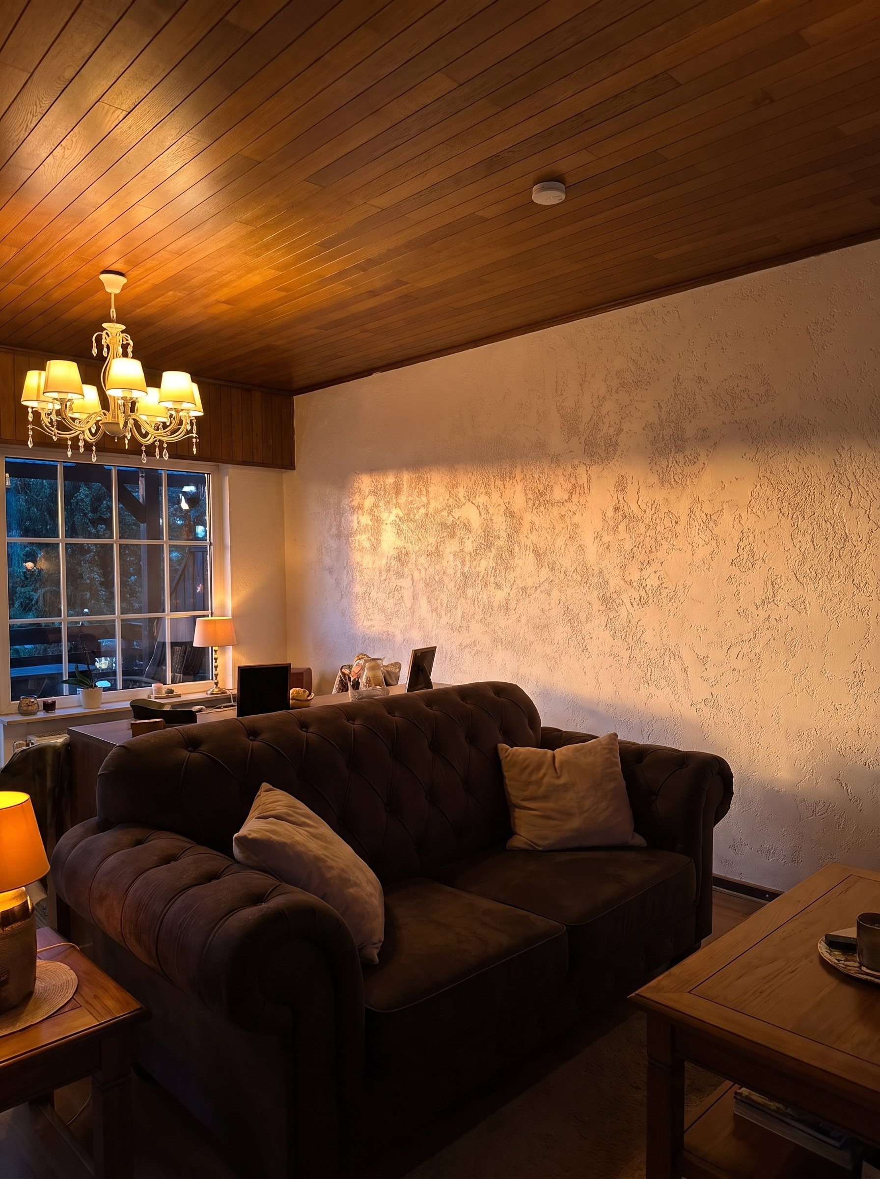 Finished living-room wall beneath a wood ceiling